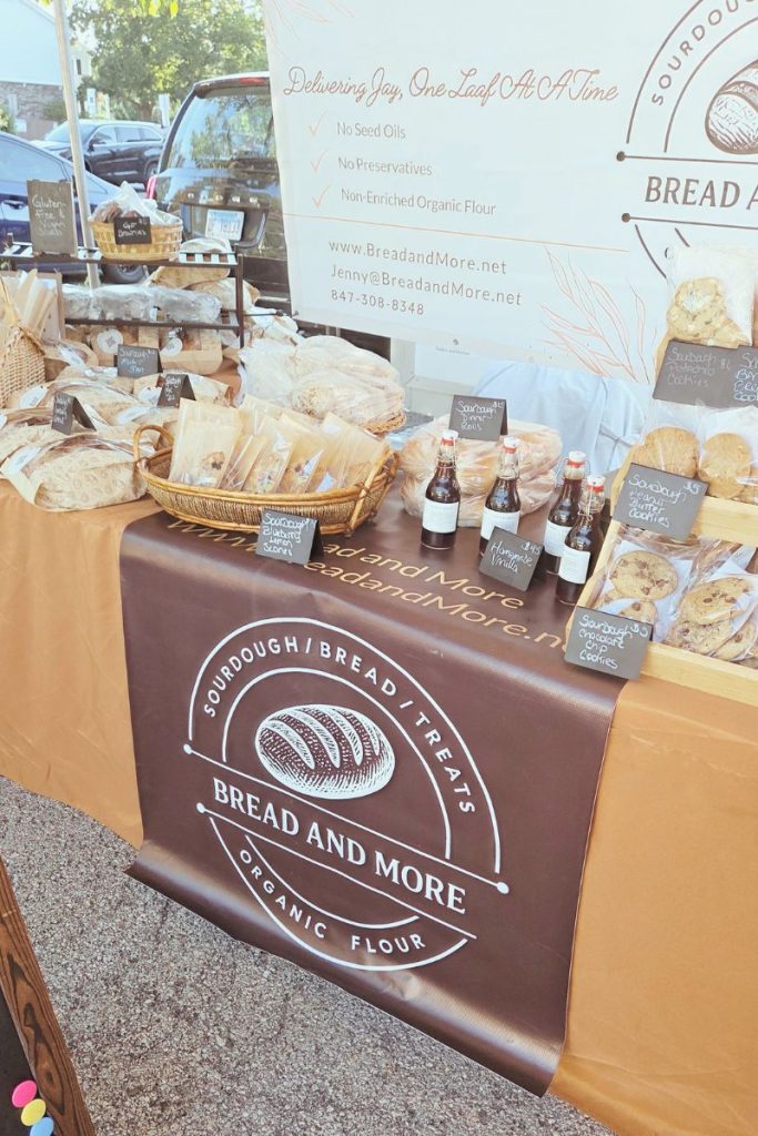 Holiday market booth set up with sourdough loaves and baked goods displayed by a micro bakery